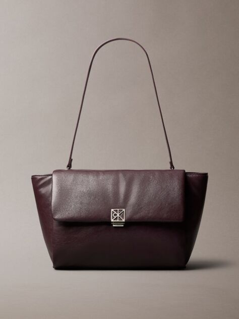 Red Defined by elegant, contemporary design, this collection features softly padded faux leather in elevated silhouettes. Finished with shiny Calvin Klein emblem hardware for a signature look  Women