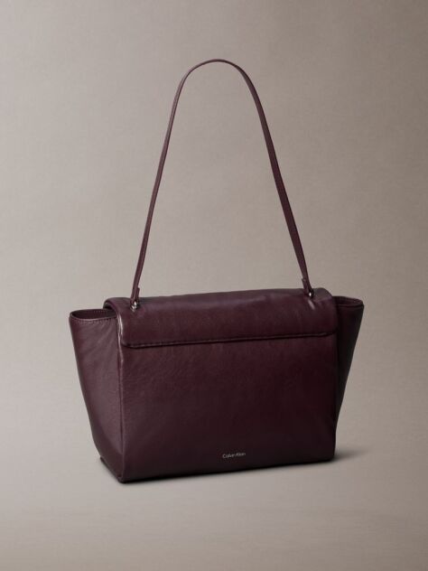 Red Defined by elegant, contemporary design, this collection features softly padded faux leather in elevated silhouettes. Finished with shiny Calvin Klein emblem hardware for a signature look  Women