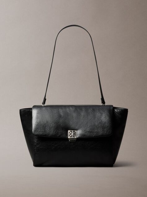Black Defined by elegant, contemporary design, this collection features softly padded faux leather in elevated silhouettes. Finished with shiny Calvin Klein emblem hardware for a signature look  Women