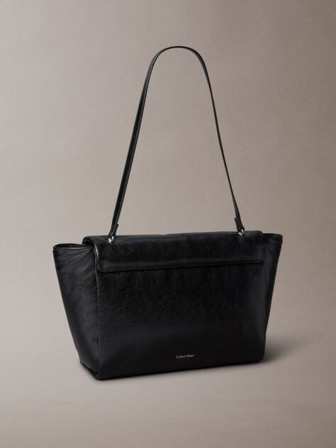Black Defined by elegant, contemporary design, this collection features softly padded faux leather in elevated silhouettes. Finished with shiny Calvin Klein emblem hardware for a signature look  Women