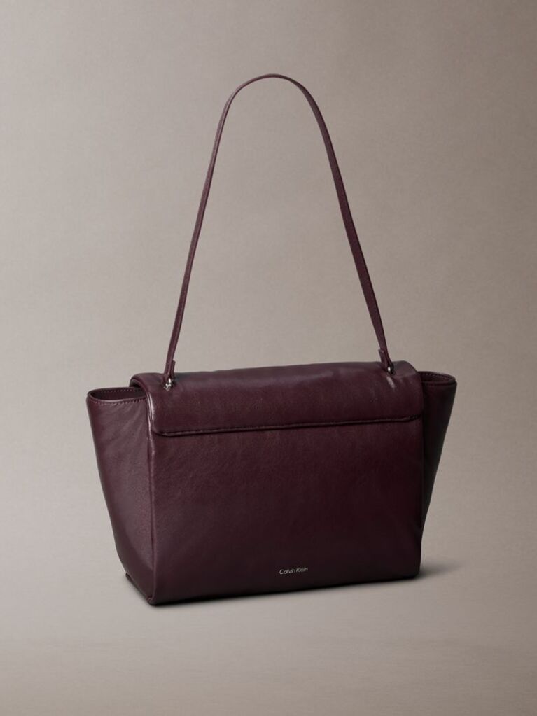 Red Defined by elegant, contemporary design, this collection features softly padded faux leather in elevated silhouettes. Finished with shiny Calvin Klein emblem hardware for a signature look  Women