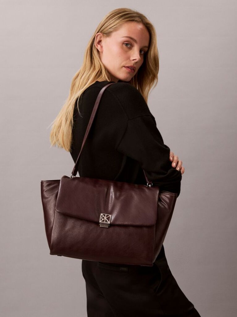 Red Defined by elegant, contemporary design, this collection features softly padded faux leather in elevated silhouettes. Finished with shiny Calvin Klein emblem hardware for a signature look  Women